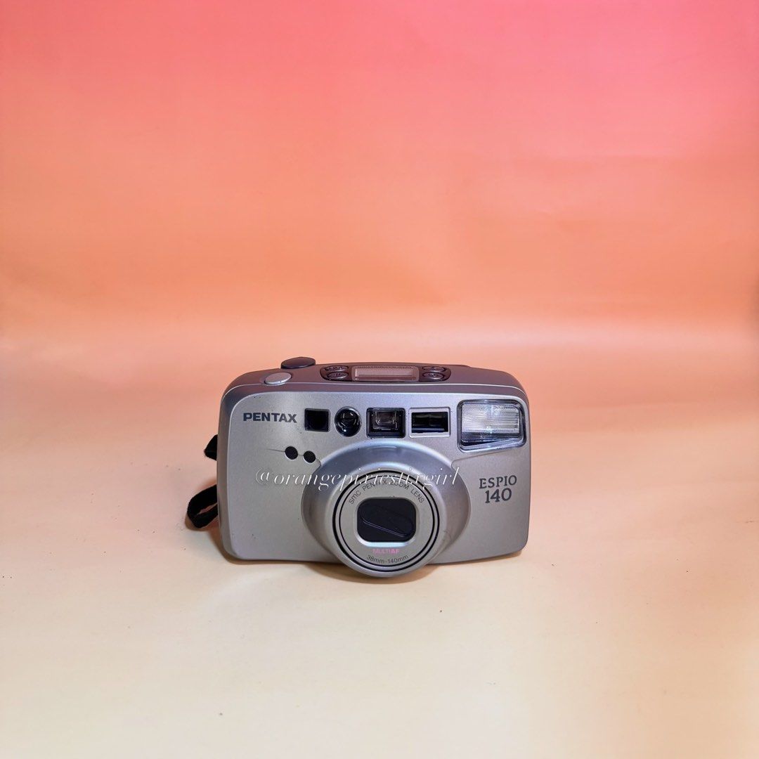 Pentax Espio 140 35mm Film Camera (Category: Cameras) located in Bulacan. Submitted by orangepixiestixgirl (Listing ID 1467164563, Image 1). Description: ‼️message me on ig, @orangepixiestixgirl for inquiries and transactions‼️ ‼️CAN’T REPLY HERE‼️ Pentax Espio 140 35mm Film Camera —35mm film camera with fully automatic exposure, film advance, and rewind. —38–140mm power zoom lens. —Multi-point active autofocus system. —Flash and Zoom working. —U