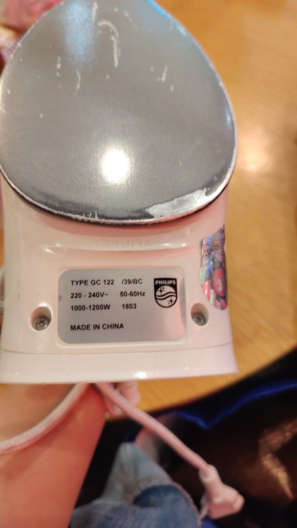 Philips Diva GC122 Iron (Category: Irons & Steamers) located in Manila. Submitted by purediamond888 (Listing ID 1467047559, Image 3). Description: - Brand/Model: Philips Diva (GC122) - Power: 1000-1200W, 220-240V - Design: White and purple body Lightweight with top temperature control dial and attached cord - Condition: Pre-loved with visible scratches and wear marks on the soleplate - Authenticity: Original hologram sticker intact on the side - 
