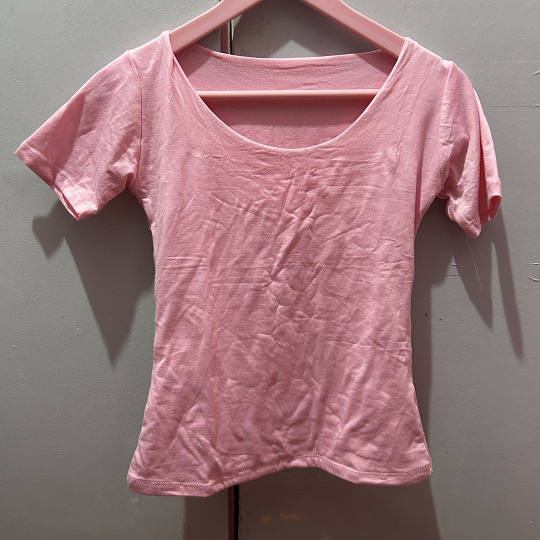 Pink coquette scoop neck short sleeve basic top (Category: Shirts) located in Mandaluyong City. Submitted by strawbyeries (Listing ID 1467141640, Image 1). Description: - Color: Pink - Style: Fitted short-sleeve tee with low scoop neckline - Material: Soft, breathable cotton for everyday wear - Versatility: Pairs great with high-waisted jeans and skirts - Condition: Excellent, clean fabric with no stains or holes.