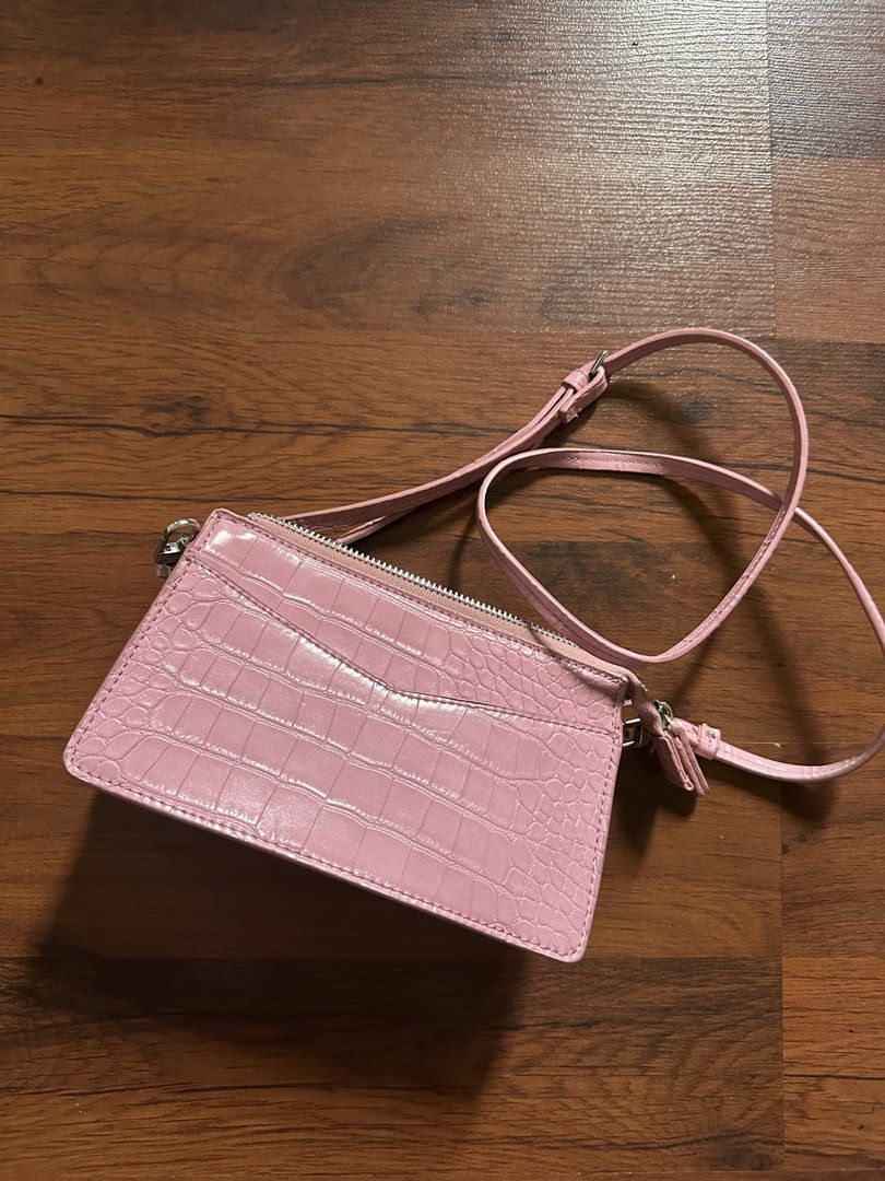 Pink Croc Embossed Double Zip Crossbody Bag with Chain (Category: Cross-body Bags) located in Binan City. Submitted by denchimmy (Listing ID 1466984530, Image 1). Description: - Trendy pink crossbody bag with a chic faux crocodile skin texture - Silver hardware and zippers with a clean pink fabric interior - Dual zipped compartments plus a convenient front exterior card slot - Ideal compact size to fit your phone, keys, and cards easily - Include
