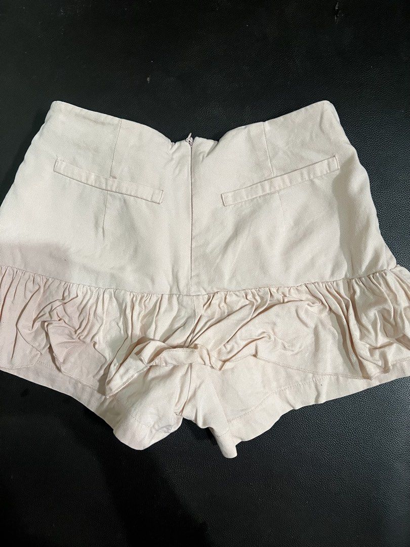 Pink ruffle hem shorts with back zipper (Category: Shorts) located in Manila. Submitted by rhiangastadora (Listing ID 1467043746, Image 2). Description: - Color: Light pink - Style: Structured fabric with a flared ruffle hem - Waist: Mid to high rise - Closure: Convenient back zip - Details: Two back faux welt pockets for a clean look - Condition: Great piece, easy to style with casual tops Free if you buy an item from me..