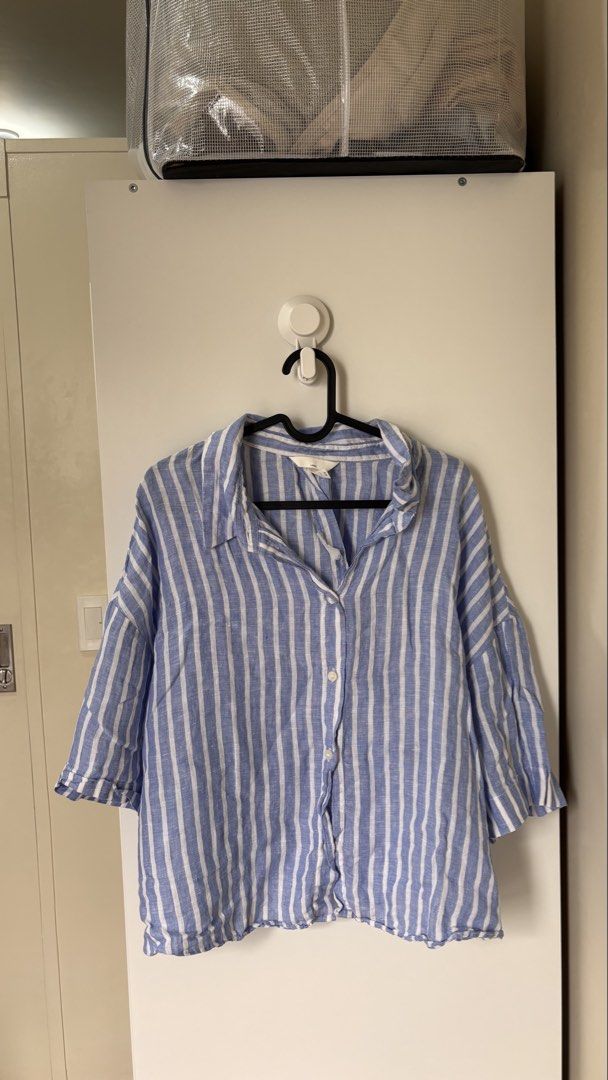 Plus Size H&M Linen Blue White Striped Button Down Shirt (Category: Tshirts & Polo Shirts ) located in Mandaluyong City. Submitted by decltqueen (Listing ID 1467002284, Image 1). Description: H&M blue and white striped linen shirt in Size XL on tag. Can fit till 3XL. Lightweight, breathable, and perfect for hot weather. Features a classic collar, front buttons, and 3/4 sleeves in a relaxed fit..