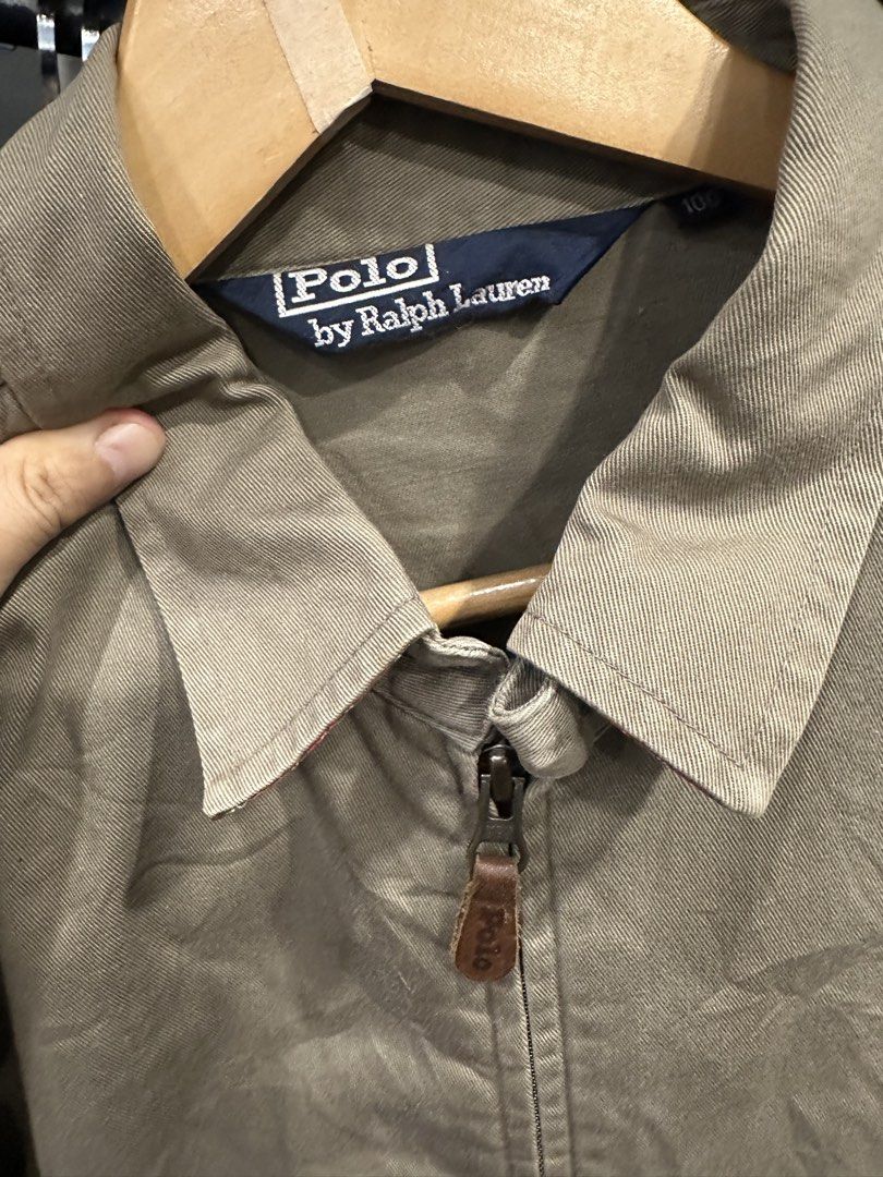 Polo by Ralph Lauren Khaki Zip-Up Jacket (Category: Coats, Jackets and Outerwear) located in Makati City. Submitted by hehehekdeg (Listing ID 1467029310, Image 2). Description: - Harrington Polo by Ralph Lauren - Color: Classic Khaki - Material: 100% sturdy cotton - Size: Tag size 100 - Details: Full zip with leather pull, pointed collar, side welt pockets, ribbed hem - Logo: Embroidered pony on left chest - Condition: Pre-loved, well-maintained.