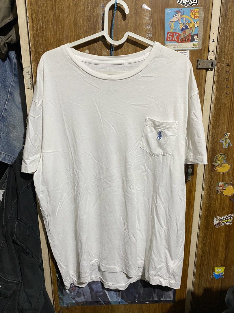 Polo Ralph Lauren White Pocket Tee (Category: Tshirts & Polo Shirts ) located in Imus. Submitted by frootiloots4103 (Listing ID 1467153221, Image 1). Description: - Brand: Polo Ralph Lauren - Color: Classic White - Material: 100% Cotton (Soft and comfortable) - Size: Chest measures approx. 23 inches, Length measures approx. 28 inches - Features: Crew neck, chest pocket with iconic blue embroidered pony logo - Origin: Made in Bangladesh - Conditio