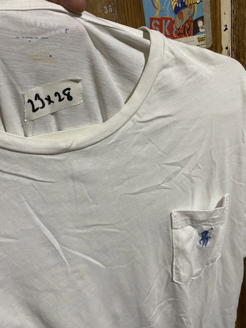 Polo Ralph Lauren White Pocket Tee (Category: Tshirts & Polo Shirts ) located in Imus. Submitted by frootiloots4103 (Listing ID 1467153221, Image 2). Description: - Brand: Polo Ralph Lauren - Color: Classic White - Material: 100% Cotton (Soft and comfortable) - Size: Chest measures approx. 23 inches, Length measures approx. 28 inches - Features: Crew neck, chest pocket with iconic blue embroidered pony logo - Origin: Made in Bangladesh - Conditio