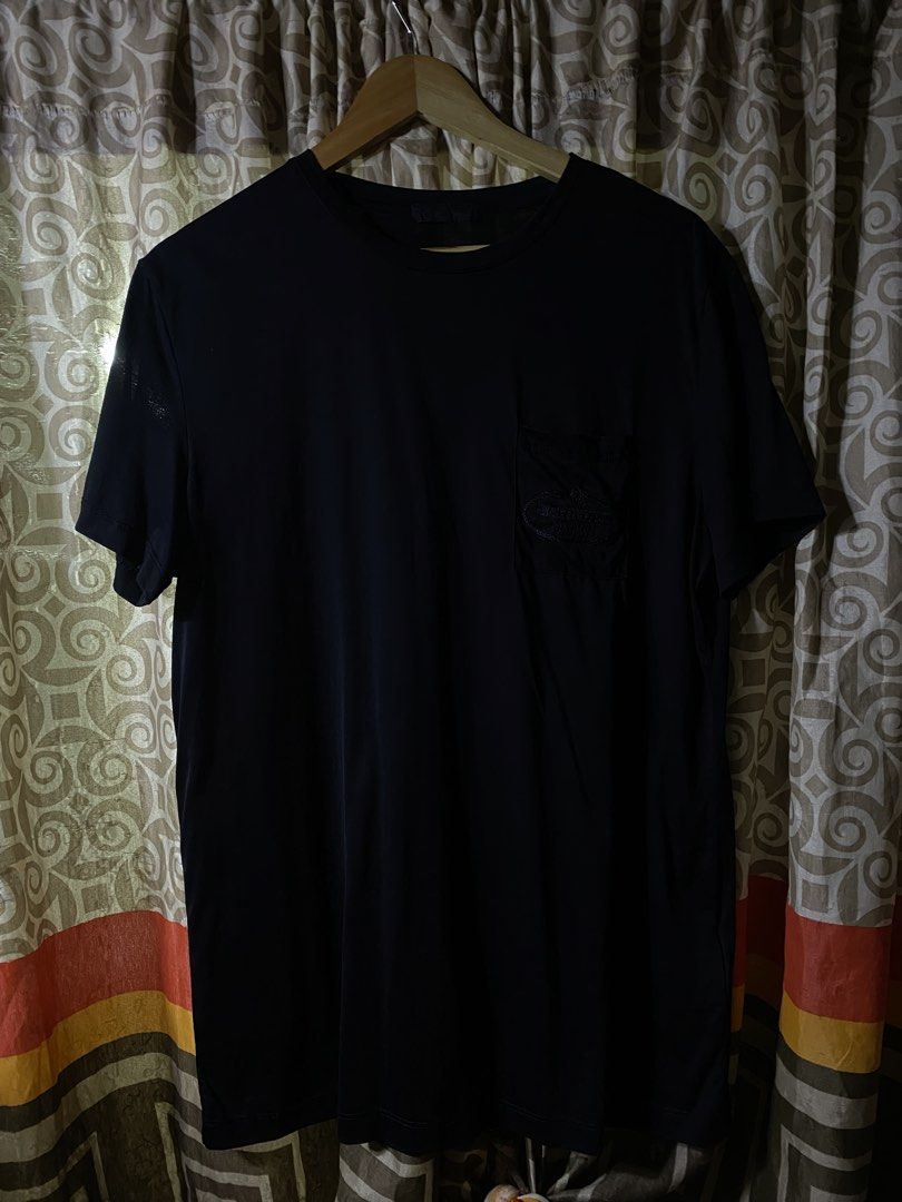 Prada Black Pocket T-Shirt Size L (Category: Tshirts & Polo Shirts ) located in Manila. Submitted by kentmarion.water (Listing ID 1467128520, Image 1). Description: - Brand: Prada - Color: Solid Black - Size: Large (L) - Material: 100% Cotton (Made in Tunisia) - Fit: Regular fit, standard length - Design: Crew neck, short sleeves, chest pocket with embroidered Prada Milano logo patch - Condition: Brand new / Excellent quality - Mode of Payment: G