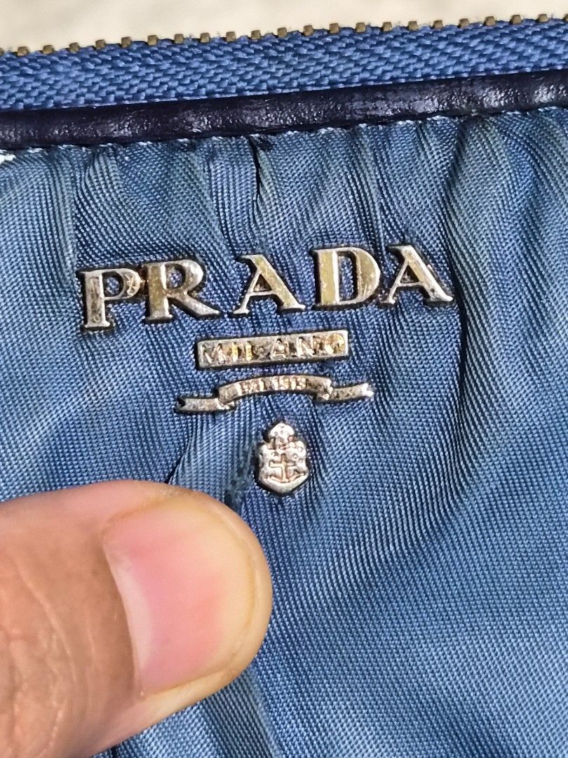 Prada Blue Nylon Zip Around Long Wallet (Category: Luxury Bags & Wallets) located in Mandaue City. Submitted by chuchi152615 (Listing ID 1466985800, Image 2). Description: - Prada long zip wallet - Material: Blue nylon with gathered pleat texture and gold-tone hardware - Interior: Beige leather lining, multiple card slots, slip compartments, and zippered coin pocket - Origin: Made in Italy - Condition: Normal signs of use on interior leather and 