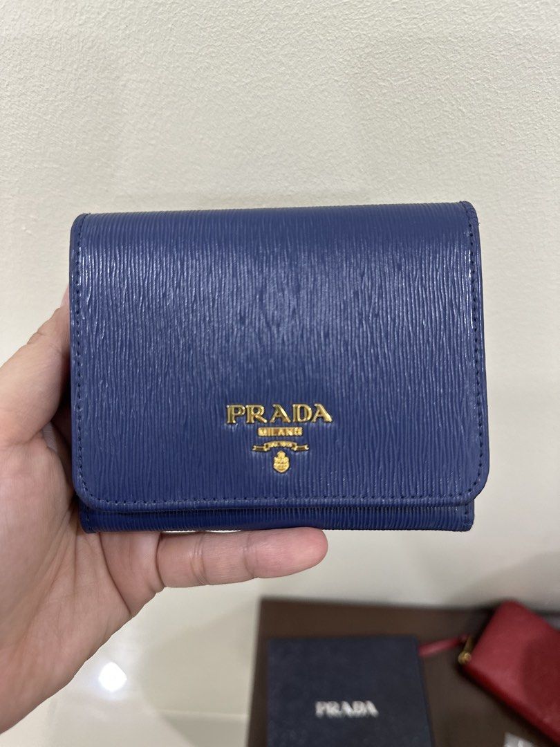Prada Blue Saffiano Leather Wallet (Category: Luxury Bags & Wallets) located in Paranaque City. Submitted by mycloset1o1 (Listing ID 1467078117, Image 1). Description: - Authentic Prada wallet in deep blue Saffiano leather - Elegant gold-toned hardware with classic Prada Milano front logo - Compact fold design featuring multiple compartments for cards and cash - Clean structure with a sturdy build for everyday use - Original box included Like new