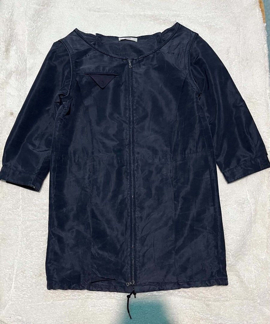 Prada Dark Blue Zip Up Jacket Made in Italy (Category: Coats, Jackets and Outerwear) located in Leyte. Submitted by carlthriftwearapparel (Listing ID 1467127852, Image 3). Description: - Authentic Prada zip-up jacket made in Italy - Elegant dark blue color with clean, minimalist design - Premium full front zipper featuring durable riri hardware - Signature small triangular pocket detail on the upper chest - Adjustable drawstring hem for a customi