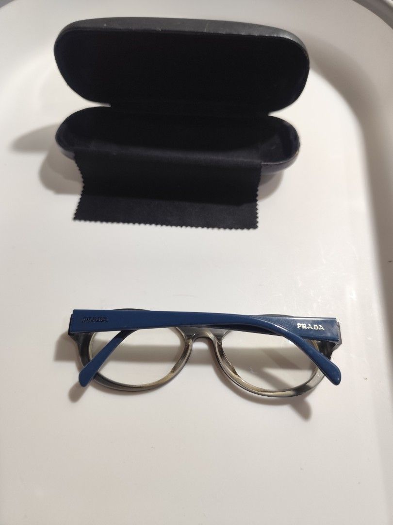 Prada Eyeglasses Blue Frame (Category: Sunglasses & Eyewear) located in Cebu City. Submitted by icoolectnsellect (Listing ID 1467149584, Image 2). Description: Issue: Minor Scratch, Dirt and RX lens. Bought at Garage Sale. Authenticity not Guaranteed, di ko alam if legit or Fake. Buy @ your own Risk. All EyeGlasses or Sun Glasses ay may Grado or Prescription Glasses. Please be careful para di masira mata nyo, you can change the lens and frame na 