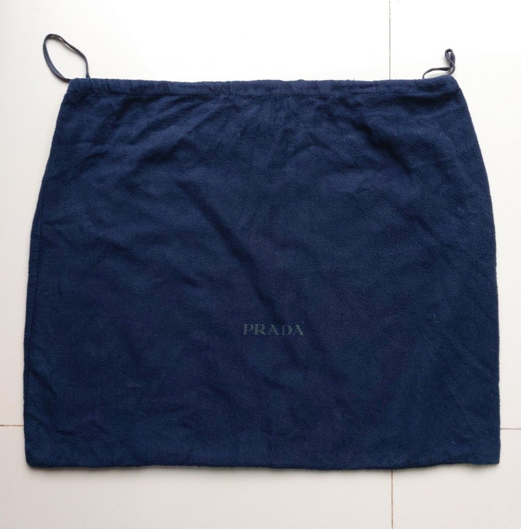 Prada Navy Blue Dust Bag (Category: Luxury Bags & Wallets) located in Lapu Lapu. Submitted by agnesapm_29813 (Listing ID 1467109981, Image 2). Description: - Authentic navy blue Prada dust bag - Features a secure drawstring closure - Iconic Prada logo stamped in black on the front - Generous size: approximately 22 inches wide x 18 inches high - Ideal for safely storing luxury bags, shoes, or accessories.