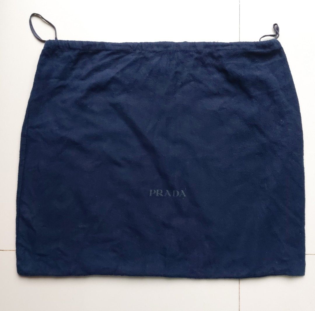 Prada Navy Blue Dust Bag (Category: Luxury Bags & Wallets) located in Lapu Lapu. Submitted by agnesapm_29813 (Listing ID 1467109981, Image 1). Description: - Authentic navy blue Prada dust bag - Features a secure drawstring closure - Iconic Prada logo stamped in black on the front - Generous size: approximately 22 inches wide x 18 inches high - Ideal for safely storing luxury bags, shoes, or accessories.
