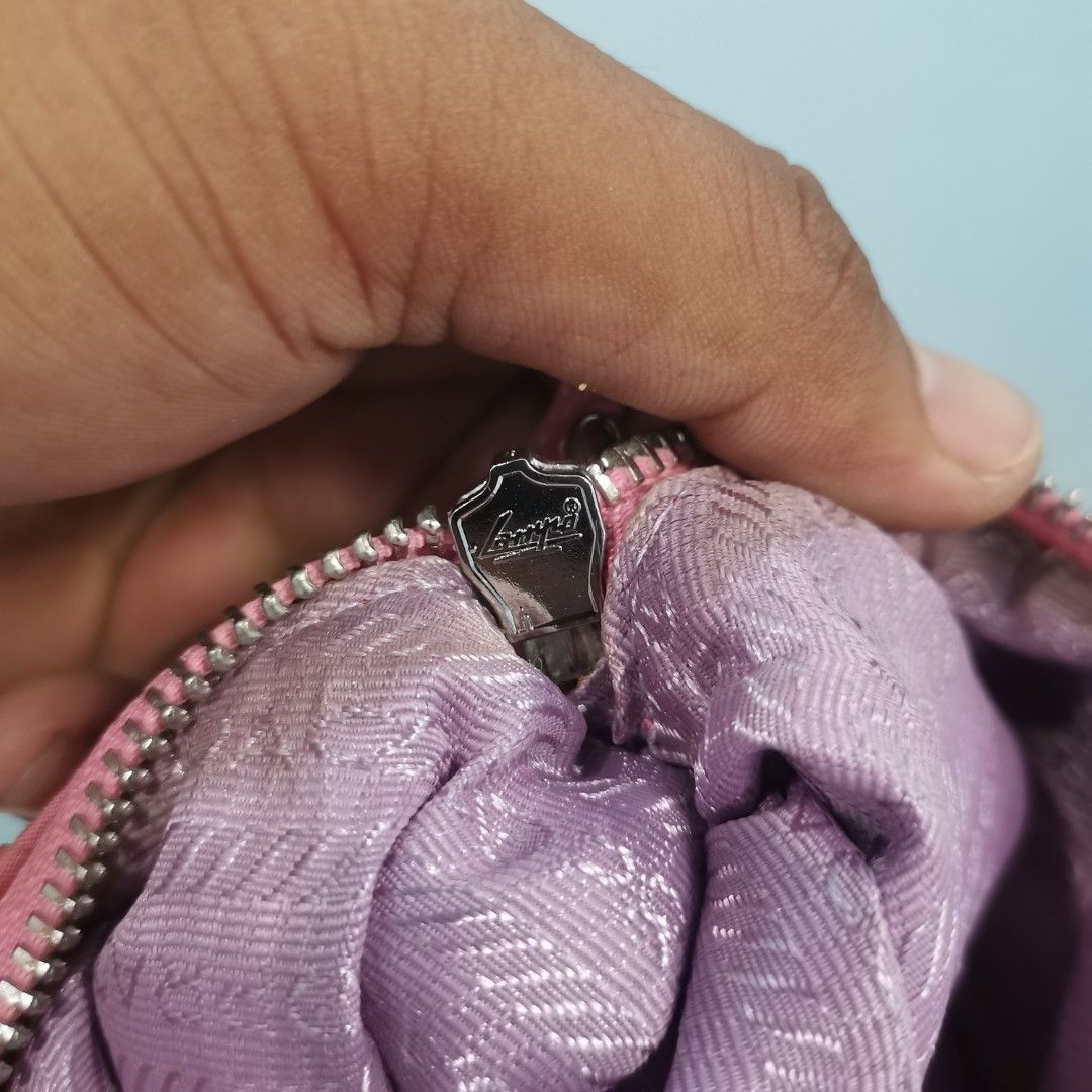 Prada Pink Ruched Nylon Shoulder Bag (Category: Luxury Bags & Wallets) located in Roxas City. Submitted by bawalthrift (Listing ID 1467039563, Image 3). Description: - Brand: Prada - Material: Pink ruched nylon with silver hardware - Closure: Secure Lampo zipper - Interior: Purple logo jacquard lining - Details: Made in Italy, tag number 175 - Style: Compact shoulder bag with single strap - Condition: Excellent pre-loved condition.