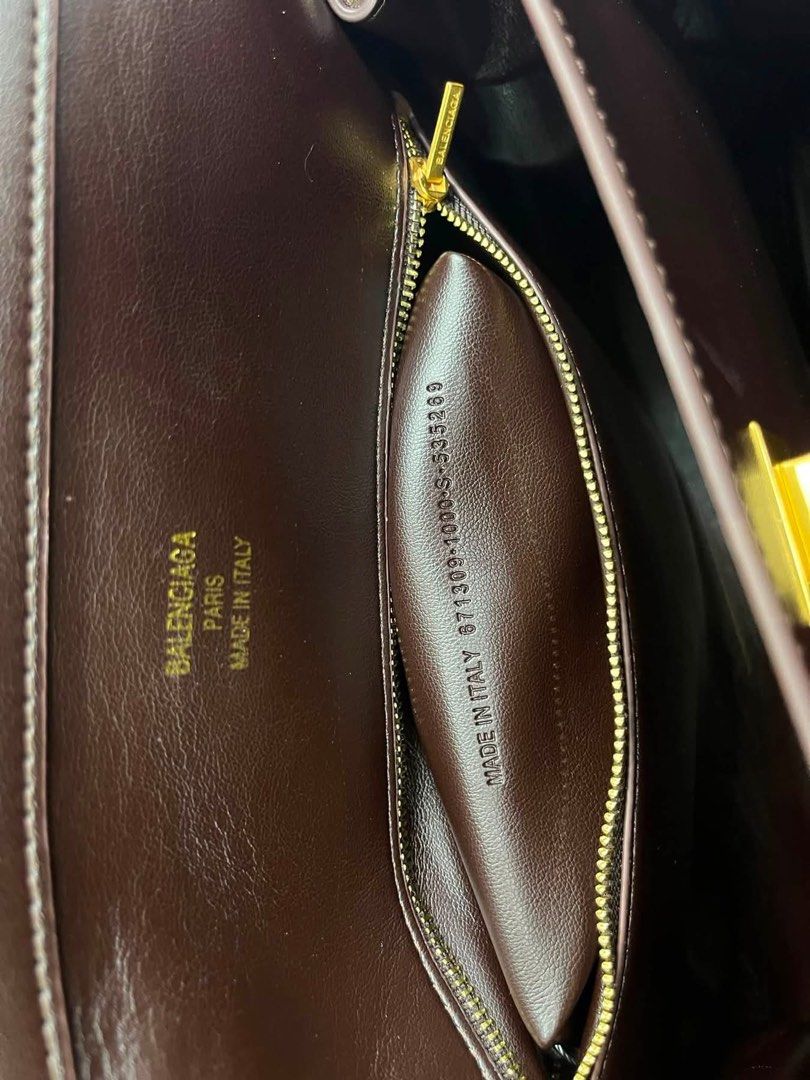 Preloved Balenciaga Rodeo Handbag Brown (Category: Luxury Bags & Wallets) located in Manila. Submitted by bagsandmanymanymore1 (Listing ID 1467077653, Image 3). Description: - Preloved Rodeo Leather Bag - Model: Rodeo Bag -Size 40cm - Color: Dark Brown - Material: Premium Leather - Hardware: Gold-tone - Closure: Front flap with twist lock - Features: Top handle, detachable shoulder strap, and leather tag charm - Interior: Multiple compartments an