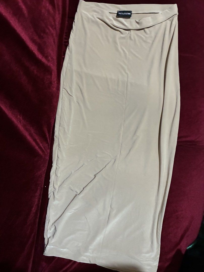 PRETTYLITTLETHING Nude Midi Skirt (Category: Skirts) located in Quezon City. Submitted by judsnasps (Listing ID 1467123341, Image 2). Description: - Brand: PRETTYLITTLETHING - Color: Nude - Length: Midi - Fit: Body-hugging with smooth, stretchy fabric - Waistband: Comfortable elastic slip-on style - Waistline: Fits 27-28 inches (has excellent stretch recovery) - Total Length: 35 inches (midi to maxi length depending on your height) - Style: Clean