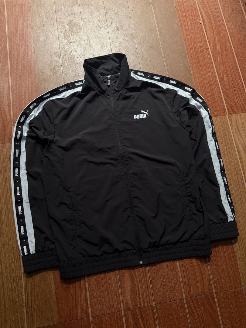 Puma Black Track Jacket with White Side Tape (Category: Coats, Jackets and Outerwear) located in Dasmarinas. Submitted by kylebecker (Listing ID 1467000890, Image 1). Description: - Authentic Puma track jacket in classic black - Eye-catching white taped sleeves with repeated logo branding - Full zip front closure with a high collar design - Snug ribbed cuffs and hem for a better fit - Convenient dual side pockets for your essentials - Clean white