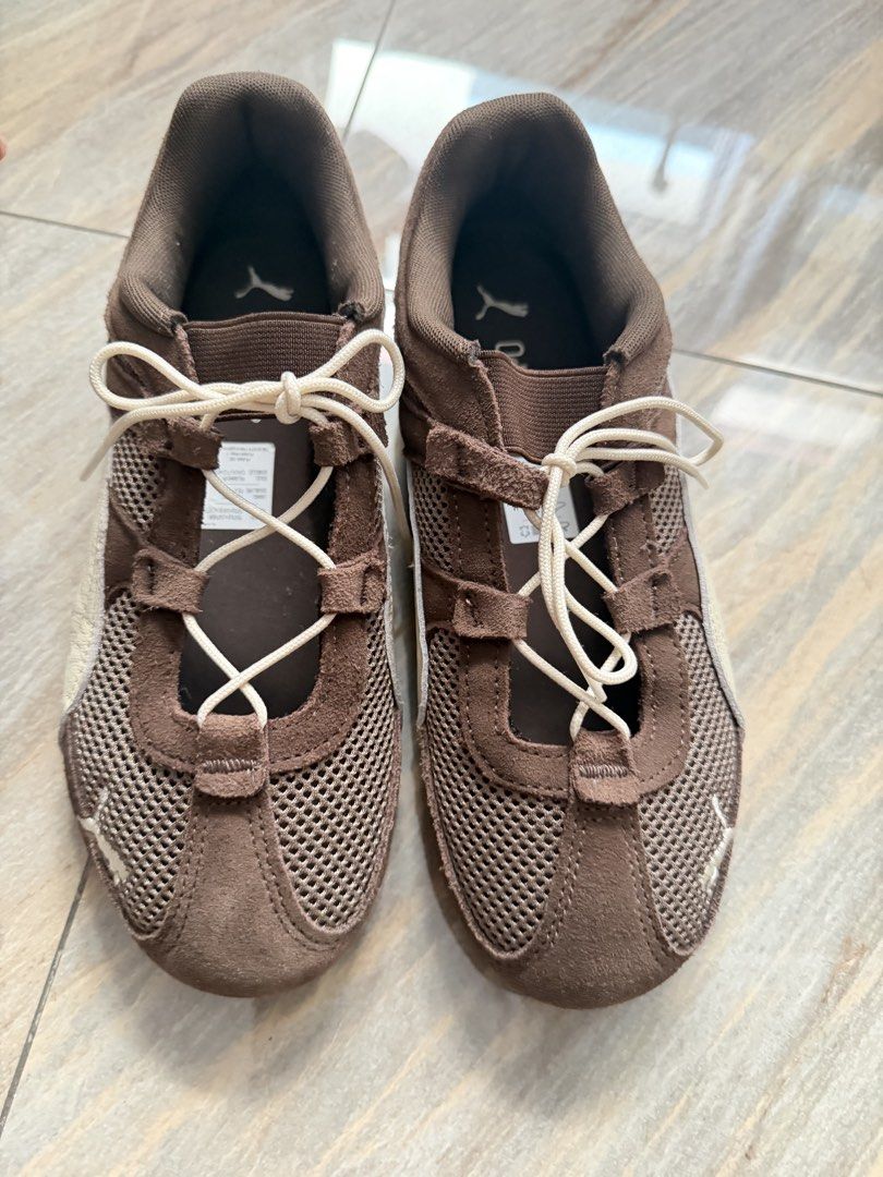 Puma Brown Mesh Lace-Up Sneakers (Category: Sneakers) located in Taytay. Submitted by gvccloset (Listing ID 1467000911, Image 1). Description: - Brand/Model: Brown Puma sneakers - Materials: Mesh panels with suede trim - Comfort: OrthoLite insoles and lightweight design - Design details: White side stripes, cream laces, and Puma logos on the tongue, heel, and outsole - Sole: Textured rubber sole with good grip - Best for: Daily walks and casual w