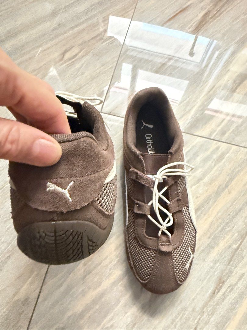 Puma Brown Mesh Lace-Up Sneakers (Category: Sneakers) located in Taytay. Submitted by gvccloset (Listing ID 1467000911, Image 3). Description: - Brand/Model: Brown Puma sneakers - Materials: Mesh panels with suede trim - Comfort: OrthoLite insoles and lightweight design - Design details: White side stripes, cream laces, and Puma logos on the tongue, heel, and outsole - Sole: Textured rubber sole with good grip - Best for: Daily walks and casual w