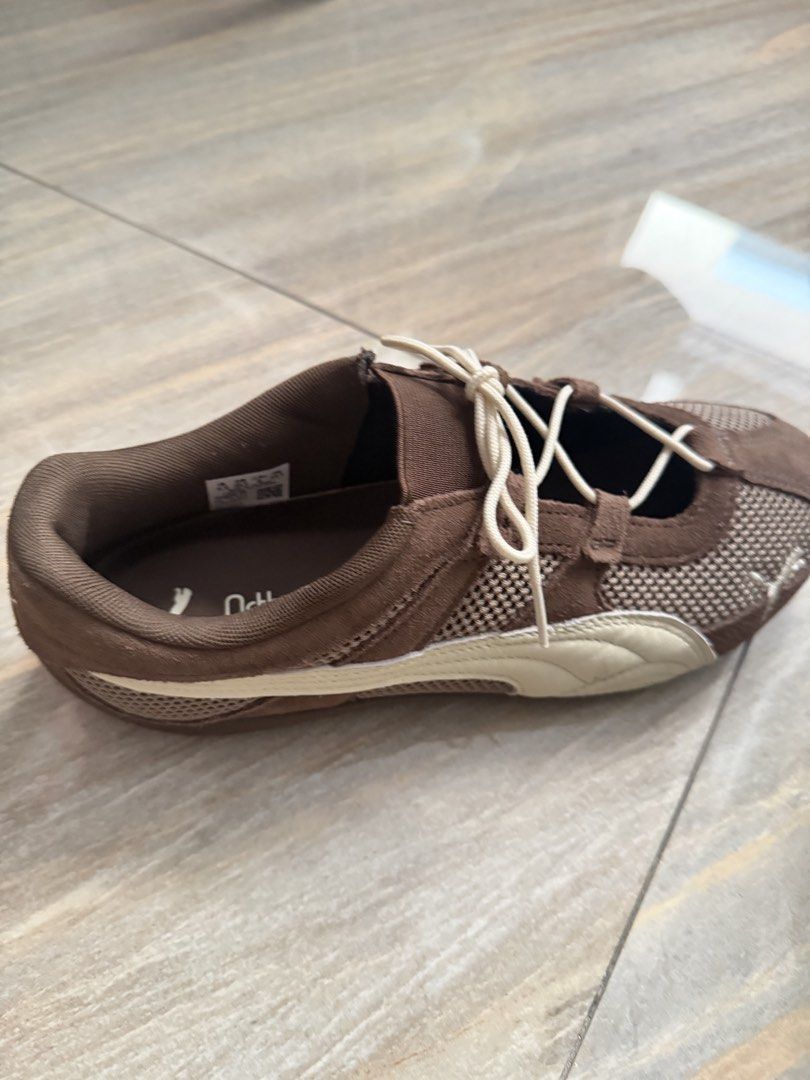 Puma Brown Mesh Lace-Up Sneakers (Category: Sneakers) located in Taytay. Submitted by gvccloset (Listing ID 1467000911, Image 2). Description: - Brand/Model: Brown Puma sneakers - Materials: Mesh panels with suede trim - Comfort: OrthoLite insoles and lightweight design - Design details: White side stripes, cream laces, and Puma logos on the tongue, heel, and outsole - Sole: Textured rubber sole with good grip - Best for: Daily walks and casual w