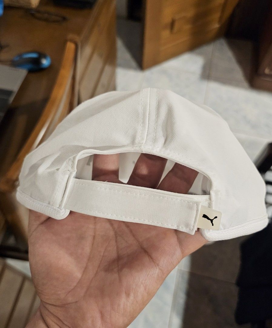 Puma White Sport Cap OSFA (Category: Caps & Hats) located in Makati City. Submitted by richpaul_ (Listing ID 1467167218, Image 2). Description: - Authentic Puma baseball cap in classic white - Features iconic black leaping cat logo on the front - Moisture-wicking grey sweatband for maximum comfort during workouts - Made from 90% polyester and 10% spandex (lightweight and flexible) - Adjustable back strap with small Puma logo tag for a custom fit 