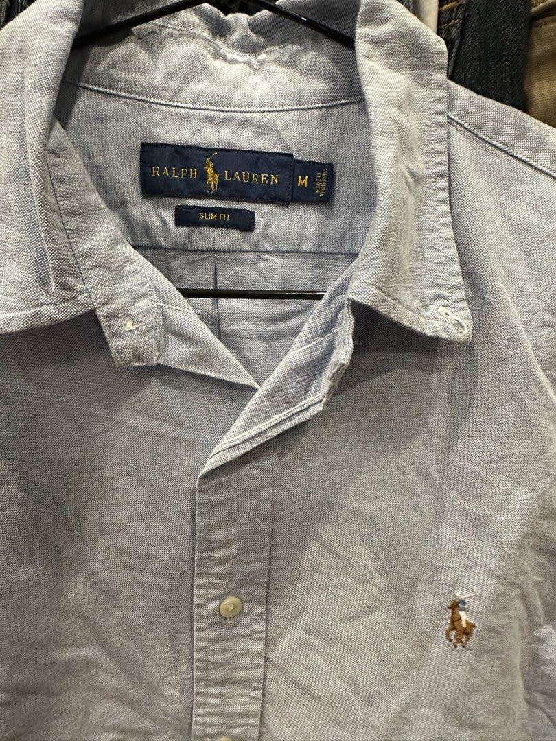 Ralph Lauren Slim Fit Light Blue Button-Down Shirt (Category: Formal Shirts) located in Makati City. Submitted by hehehekdeg (Listing ID 1467031094, Image 2). Description: - Brand: Ralph Lauren - Color: Light Blue w multi color logo - Size: Medium (Slim Fit) - Material: Classic Oxford fabric - Details: Signature brown & yellow embroidered pony logo, standard collar, button-down closure - Condition: Great wardrobe staple, perfect for casual or sma
