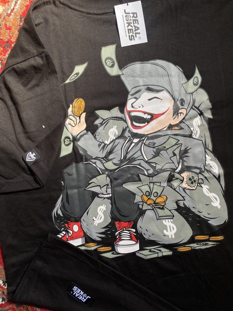 Real Jokes Black Graphic Tee (Category: Shirts) located in Manila. Submitted by nastorjeri57541 (Listing ID 1467125688, Image 3). Description: - Brand: Real Jokes - Condition: Brand new with tag, unused - Color: Black - Design: Large cartoon character surrounded by money and cash on the back, small circular logo on the front chest - Fit: Short sleeves, standard crew neck - Size: Large.