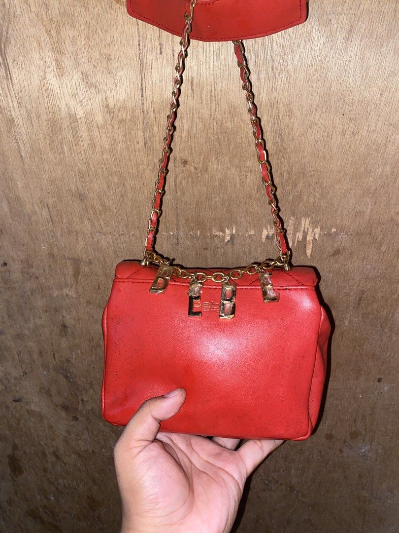 Red Bebe Quilted Shoulder Bag with Chain Strap (Category: Luxury Bags & Wallets) located in Caloocan City. Submitted by cleverwater.ba6482 (Listing ID 1467081210, Image 3). Description: - Brand: Bebe - Color: Bright red quilted - Hardware: Gold-tone chain strap with dangling logo letters and padded shoulder rest - Closure: Flap closure with decorative front clasp - Size: Compact, perfect for daily essentials - Condition: Good, with some visible m