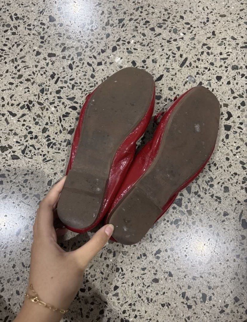 Red patent leather ballet flats with bow charm (Category: Flats & Sandals) located in Manila. Submitted by everythingwlove (Listing ID 1467028728, Image 2). Description: - Color & Material: Bright red patent leather - Style: Slip-on ballet flats with an elasticated back for easy fit - Details: Cute front bow accented with a round gold metal charm - Insoles: Cream with gold stamped lettering - Condition: Tan soles show light scuffs from outdoor wa