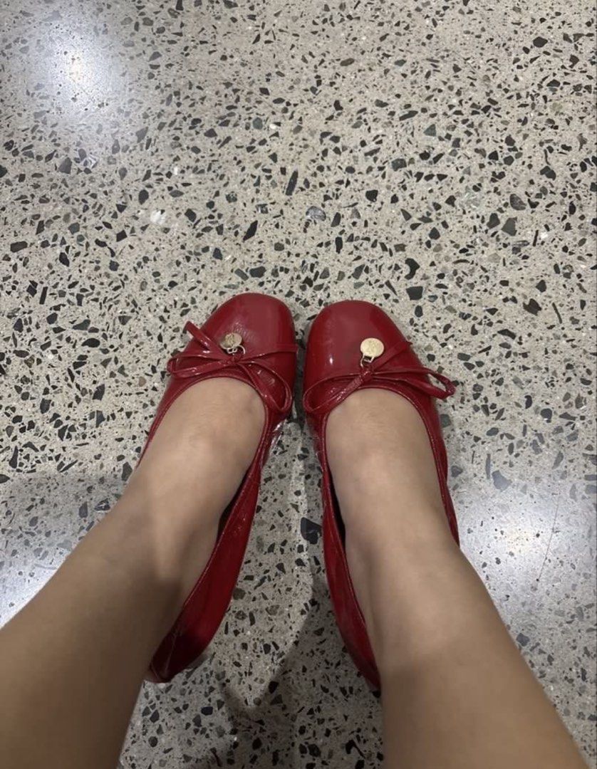 Red patent leather ballet flats with bow charm (Category: Flats & Sandals) located in Manila. Submitted by everythingwlove (Listing ID 1467028728, Image 3). Description: - Color & Material: Bright red patent leather - Style: Slip-on ballet flats with an elasticated back for easy fit - Details: Cute front bow accented with a round gold metal charm - Insoles: Cream with gold stamped lettering - Condition: Tan soles show light scuffs from outdoor wa