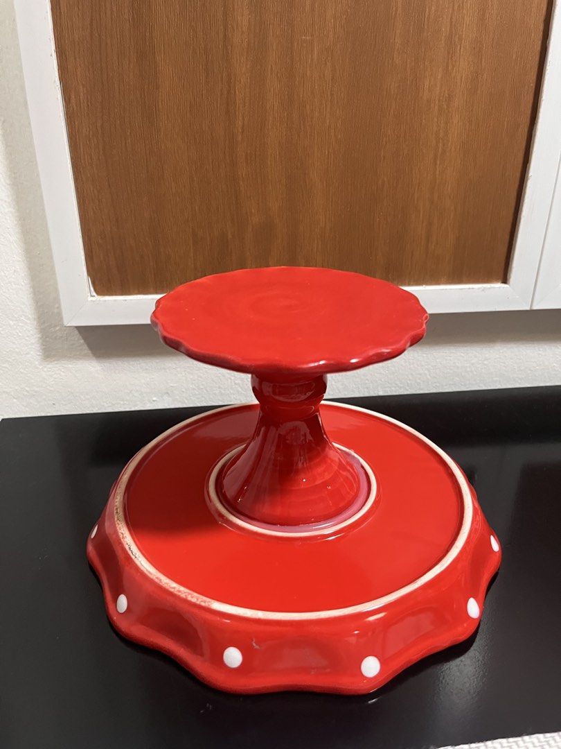 Red Polka Dot Ceramic Cake Stand (Category: Bakeware) located in Quezon City. Submitted by littleparties (Listing ID 1466971465, Image 3). Description: - Vibrant red ceramic cake stand with playful white polka dots - Elegant scalloped edge design with a glossy finish - Sturdy pedestal base for safe and secure display - Ideal for birthday parties, afternoon tea, cupcakes, and pastries - Clean condition, no chips noticed - 8”.