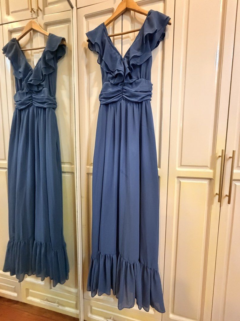 (RENT) Blue Ruffle Chiffon Dress (Category: Dresses) located in Muntinlupa City. Submitted by pennysy (Listing ID 1467054105, Image 3). Description: - Color: Dusty blue - Material: Lightweight chiffon with a beautiful drape - Length: Maxi, floor-length - Design details: V-neckline, ruffle flutter sleeves, gathered ruched waistline, flared hem, and low-cut back - Perfect for formal events, weddings, or parties TERMS: - 4 days rent - Additional day