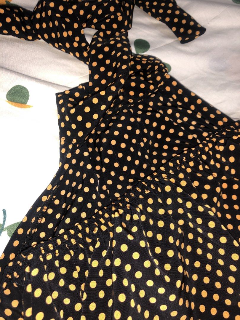 Rework Button Down Halter Top (Category: Sleeveless) located in Quezon City. Submitted by maggie.styles (Listing ID 1467131163, Image 2). Description: - Color: Black and mustard yellow - Pattern: Polka dot - Design: Halter top with tie neck straps - Details: Front button placket with metallic buttons - Fit: Smocked elastic band at the back for comfort - Fabric: Lightweight, ideal for warm weather.