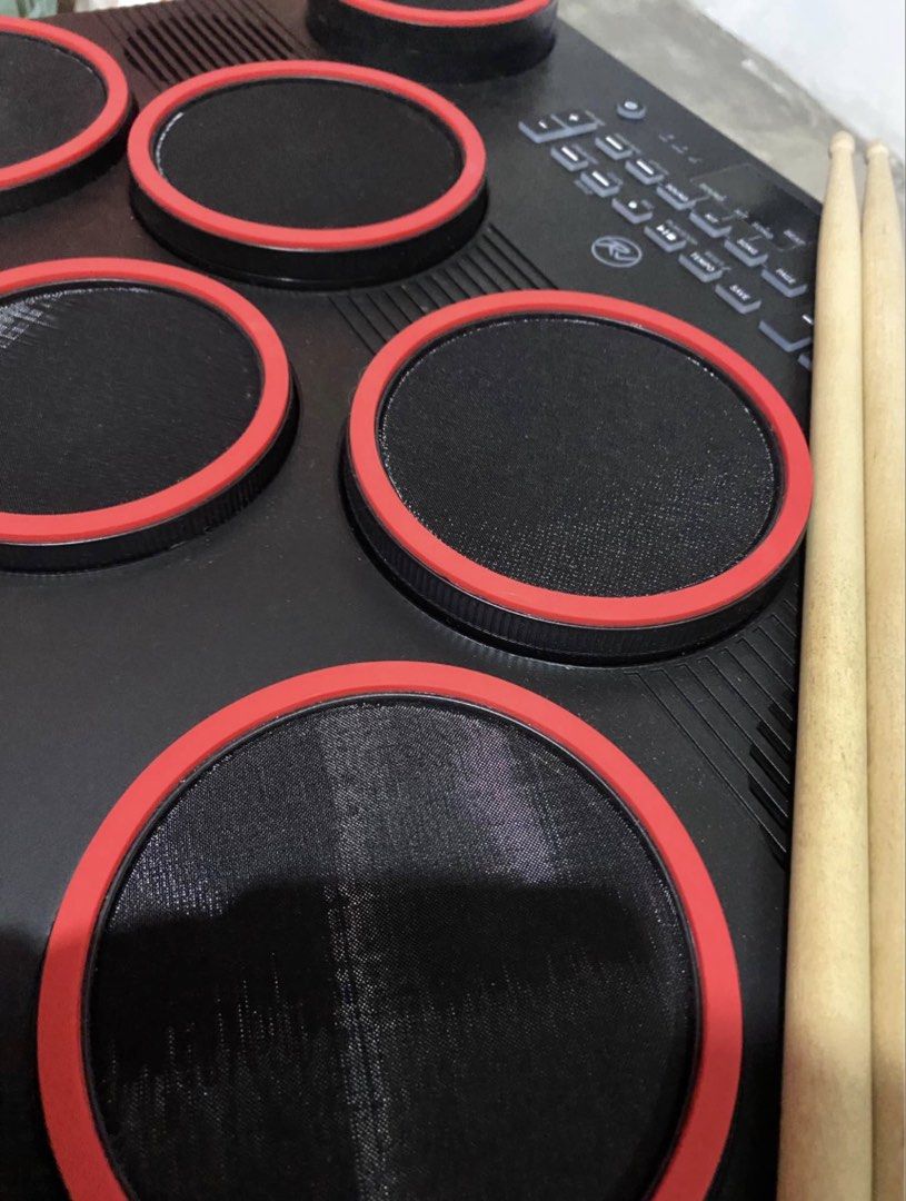 RJ Electronic Portable Drum Pad with Pedals and Sticks (Category: Musical Instruments) located in Paranaque City. Submitted by losangeles10 (Listing ID 1467086521, Image 3). Description: - Brand: RJ - Type: Portable electronic drum pad kit - Condition: Includes original box - Features: Realistic mesh pads with red rims, built-in speakers, and easy-to-use control panel - Inclusions: Drum unit, 2 pedals, power adapter, and wooden drum sticks - Perf
