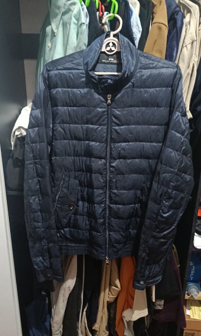 RLX puffer jacket Ralph Lauren x (Category: Coats, Jackets and Outerwear) located in Jaen. Submitted by vinzyrus217291 (Listing ID 1466992548, Image 2). Description: - 20.5x26 - 20.5 width 26 length - black and dark blue in color - dual front zip with snap button - 4 outer pockets 1 secret pocket - with tags issue: may sign of usage sa cuff snap buttons and may brown na nadikit sa loob Nueva ecija location 📍 can do meetups or shipping via jnt RL