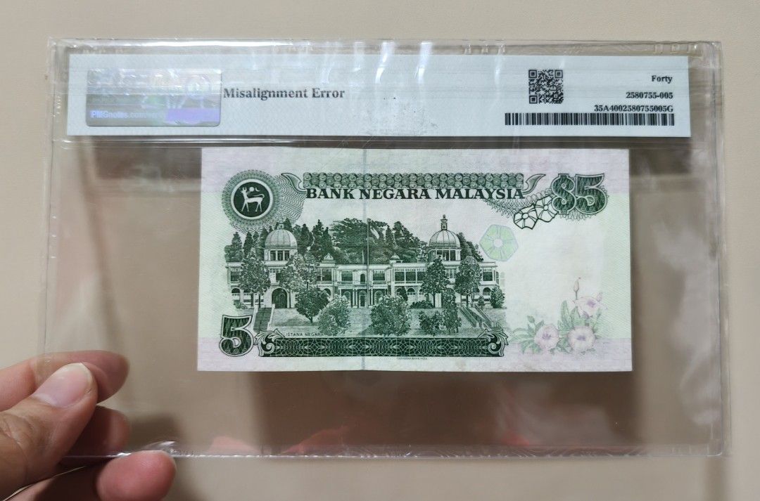 Rm5 misalignment error (Category: Currency) located in Singapore. Submitted by chongkengsin (Listing ID 1467142355, Image 2). Description: RM5 QN7649685 /7549685 PMG 40 misalignment error .
