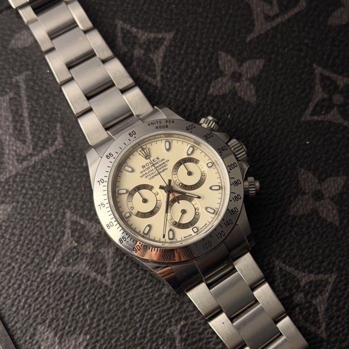 Rolex 116520 Daytona Stainless Steel White (Category: Watches) located in Singapore. Submitted by jamesnijhof (Listing ID 1467060309, Image 1). Description: White dial Rolex cosmograph Daytona for sale. Reference 116520, full steel. 2004 set with papers and receipt from hour glass Singapore. The white dial has developed a creamy yellow color. In good condition with scratches around bracelet. No huge dents or dings, crystal is clear. Pm to view or