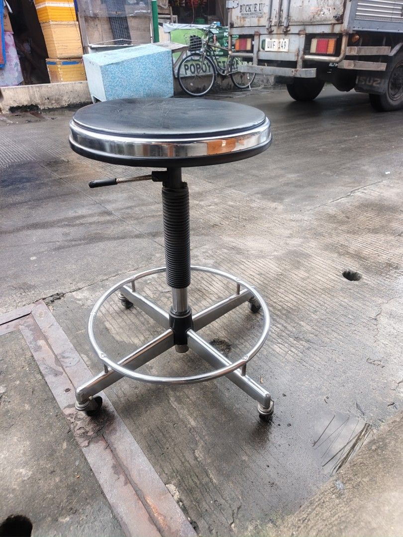 Rolling drafting stool with adjustable height and footring (Category: Chairs) located in Valenzuela. Submitted by kendra071914 (Listing ID 1466993512, Image 2). Description: - Color/Material: Black padded seat with sleek shiny chrome trim - Height: Easily adjustable from 46cm to 64cm via lever - Mobility: Built-in circular footrest and 5 smooth-rolling caster wheels - Dimensions: 37cm seat diameter with a sturdy 63cm base span - Condition: Sturdy