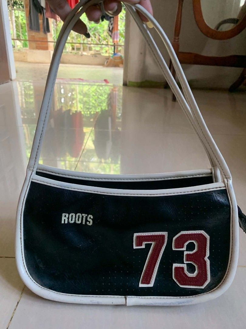 Roots 73 black and white shoulder bag (Category: Shoulder Bags) located in Tiaong. Submitted by cdoswan (Listing ID 1467015438, Image 1). Description: - Authentic Roots 73 shoulder bag in a stylish black and white faux leather finish - Features striking white piping and a bold number 73 graphic with brand detailing on the front - Equipped with comfortable double shoulder straps for easy carrying - Interior includes a fabric lining, a zippered poc
