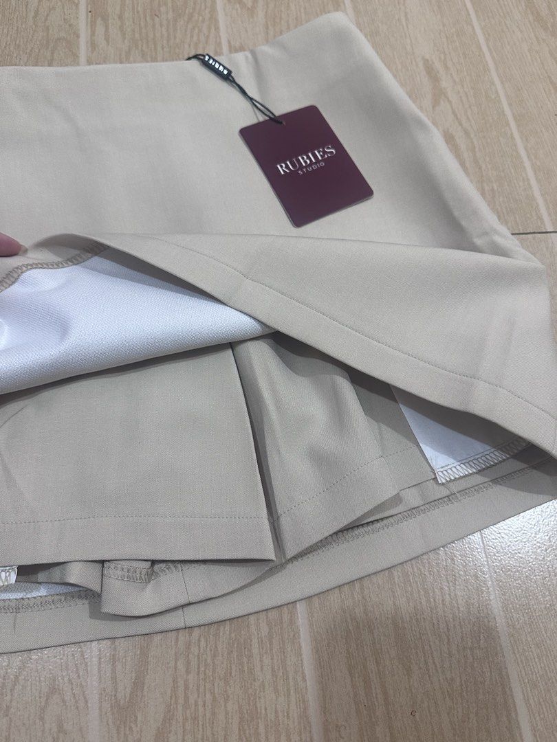 Rubies Moji Skirt (Category: Skirts) located in Manila. Submitted by lianne_a (Listing ID 1467007072, Image 3). Description: - Brand: Rubies - Condition: Brand new with tags (BNWT), never worn - Color: beige - Closure: Convenient side zipper with inner shorts - best fits size 26 Rfs: Wrong color from pasabuy Originally bought it for ₱1.4k Message me if interested. Delivery c/o buyer.