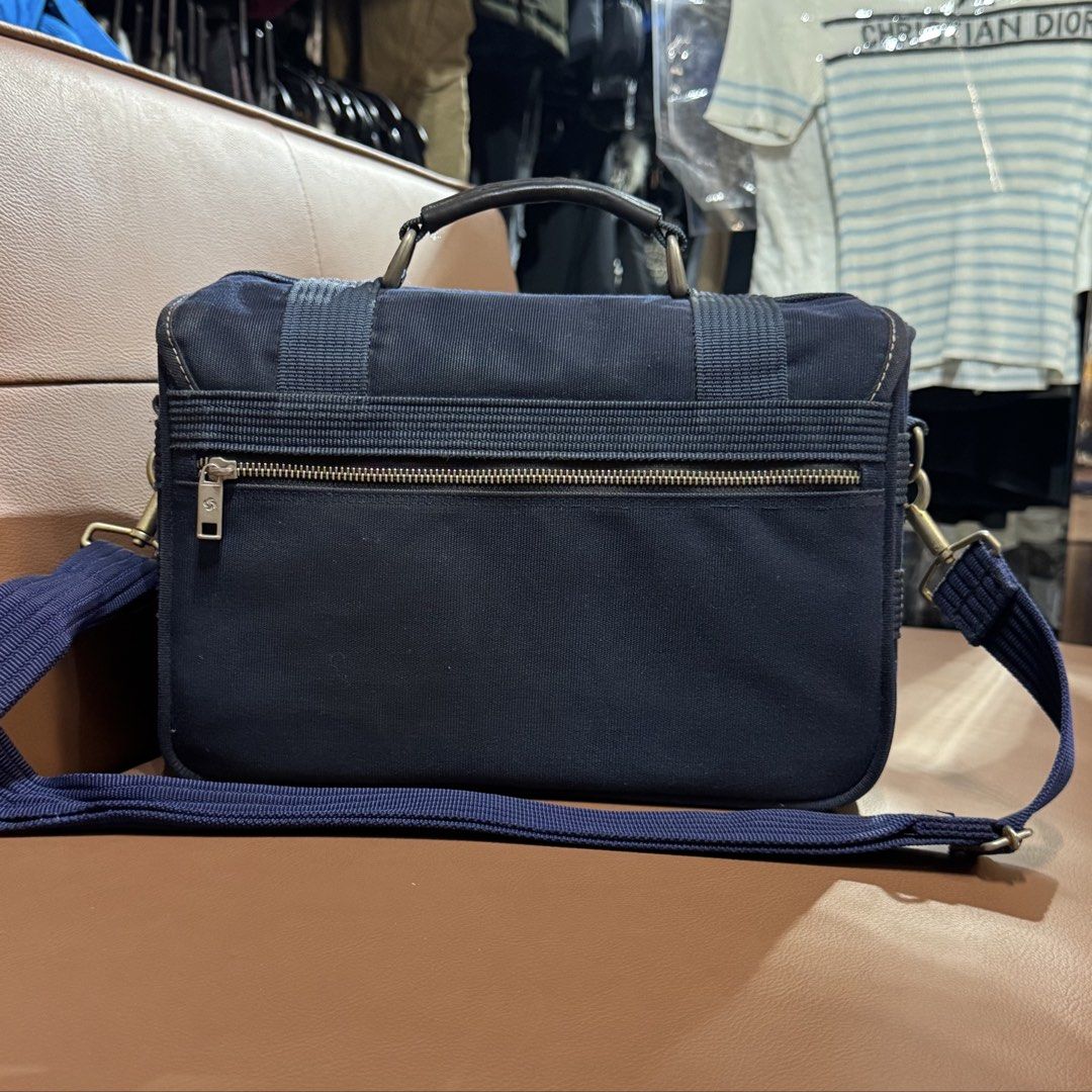 Samsonite Blue Canvas Camera Bag Messenger Bag (Category: Sling Bags) located in Rizal. Submitted by houseofbell (Listing ID 1467155374, Image 3). Description: - Brand: Samsonite - Color: Navy blue - Material: Durable canvas - Versatile Use: Ideal for camera gear or daily essentials - Design: Structured shape with top handle and adjustable shoulder strap - Closure & Storage: Twist-lock front closure, front/back zippers, and a zipped mesh pocket o