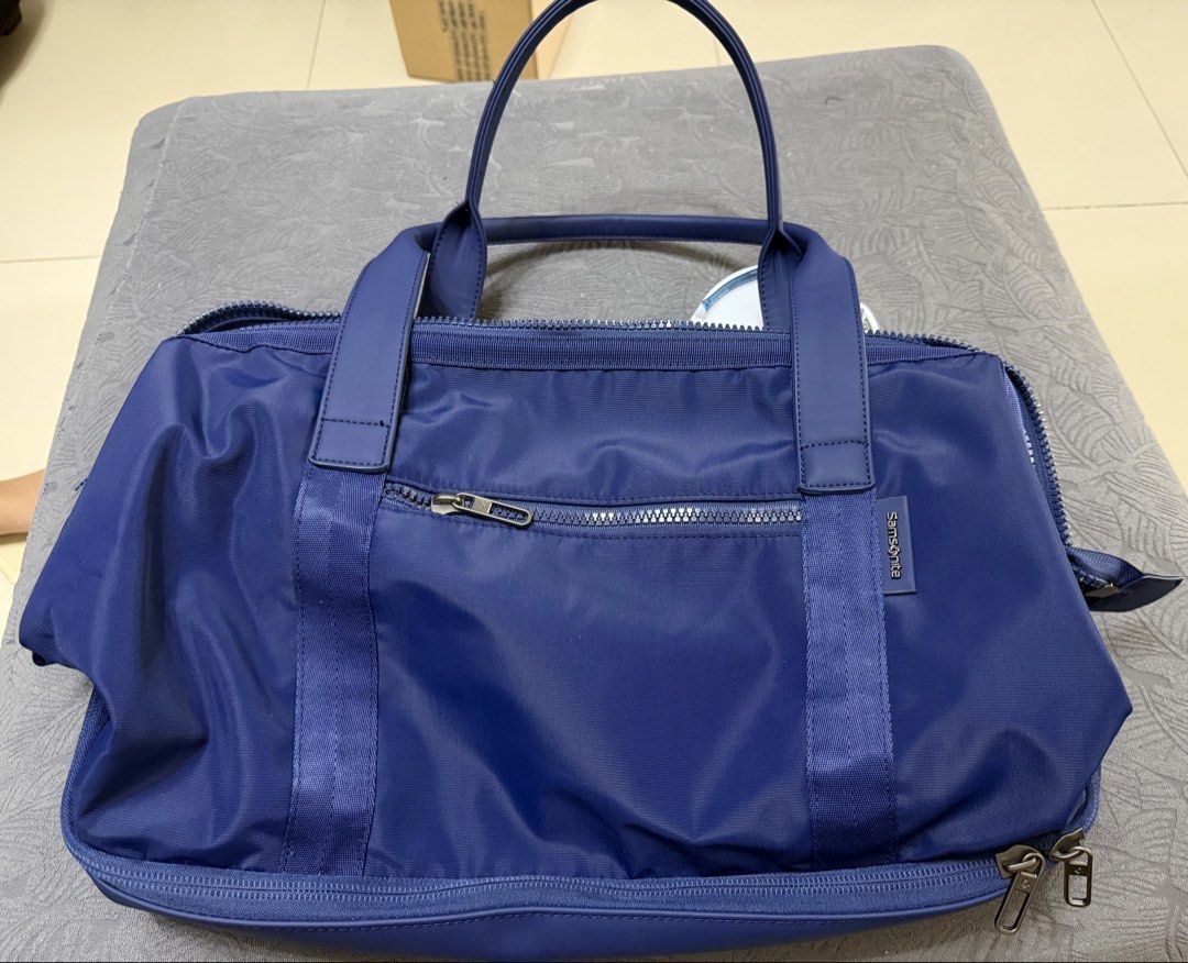 Samsonite Drop Bottom Weekender Bag Blue (Category: Sling Bags) located in Quezon City. Submitted by jamboreeee (Listing ID 1467074143, Image 2). Description: - Brand new removed tags - Vibrant blue color and durable nylon material built for travel - Drop-bottom compartment for extra packing space - Convenient dual top carry handles and included shoulder strap - Front zipper pocket for quick-access items SRP is 60$.