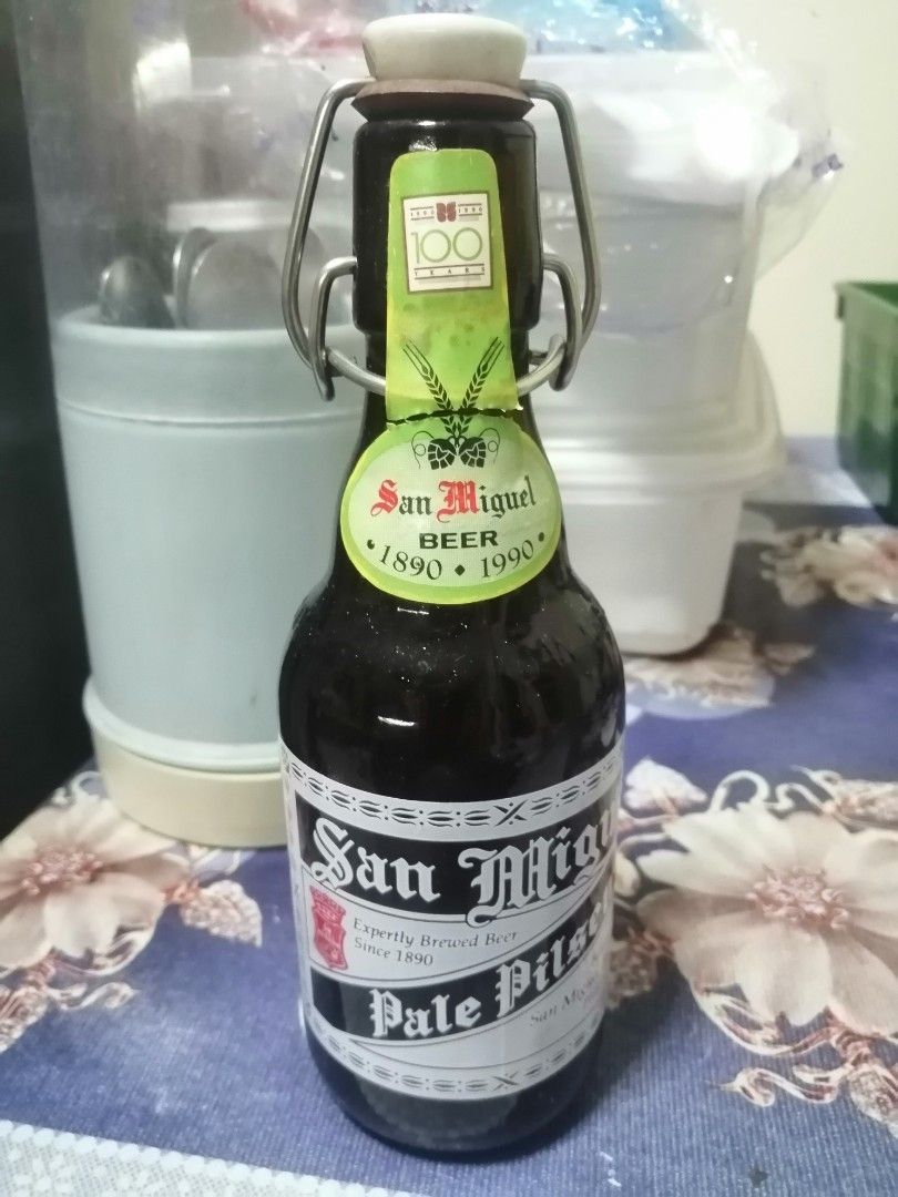 San Miguel Centennial Bottle (Category: Vintage Collectibles) located in Pateros City. Submitted by romferarc333 (Listing ID 1467156931, Image 2). Description: For San Miguel vintage collectors: San Miguel Beer Centennial Commemorative Bottle (1890–1990) released to celebrate the 100th anniversary of San Miguel Brewery. Key Features Design: Features a classic amber glass bottle with a distinctive porcelain swing-top (flip-top) ceramic cap rather 