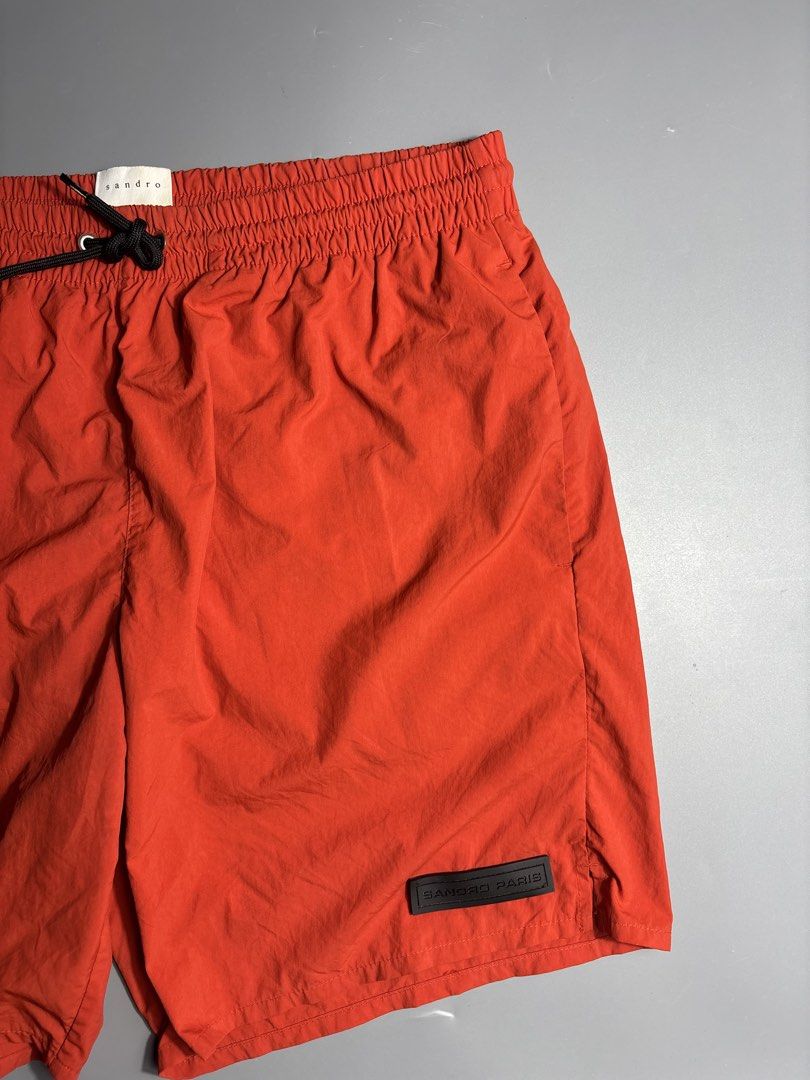 Sandro Paris Nylon Shorts (Category: Swim Trunks & Board Shorts) located in Manila. Submitted by south_finds (Listing ID 1467093769, Image 3). Description: - Brand: Sandro Paris - Color: Bright red - Waistband: Elastic with black adjustable drawstring and metal aglets - Details: Rubberized Sandro Paris logo patch near left hem - Lining: Built-in interior mesh - Reference: Model P6494S-51 - Condition: Excellent / Like new.