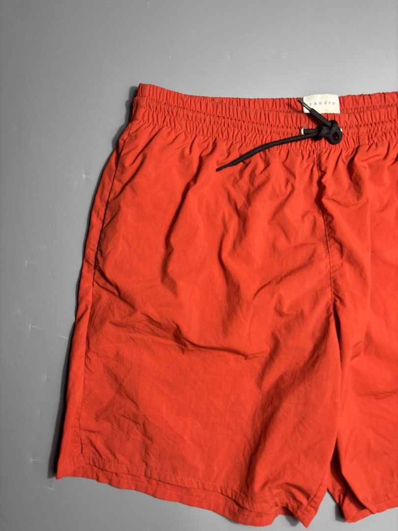 Sandro Paris Nylon Shorts (Category: Swim Trunks & Board Shorts) located in Manila. Submitted by south_finds (Listing ID 1467093769, Image 2). Description: - Brand: Sandro Paris - Color: Bright red - Waistband: Elastic with black adjustable drawstring and metal aglets - Details: Rubberized Sandro Paris logo patch near left hem - Lining: Built-in interior mesh - Reference: Model P6494S-51 - Condition: Excellent / Like new.