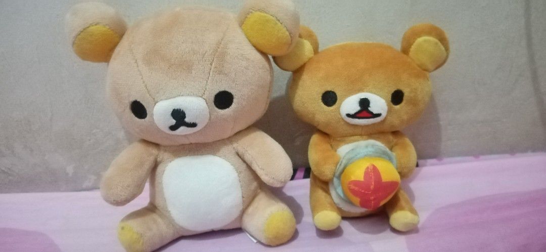 San-x Rilakkuma Plush Toy Set (Category: Plushies & Soft Toys) located in Bulacan. Submitted by renasophiatoystore2020 (Listing ID 1467102912, Image 1). Description: - Authentic San-x Rilakkuma plush set of 2 - Includes: 1 larger light brown bear and 1 smaller dark brown bear with a yellow food item - Condition: Clean overall, super soft fabric - Authenticity: Original white and yellow San-x tags attached - Perfect for San-x collectors and Rilakk