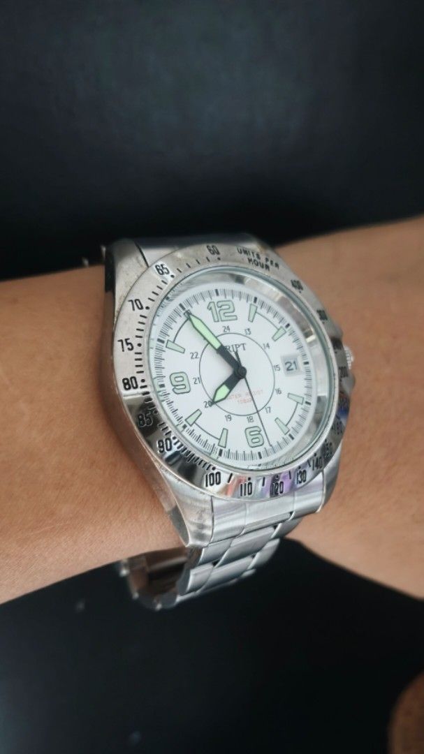Script White Dial Luminous hands Big face Mens Watch Japan (Category: Men's Watches) located in Taguig. Submitted by mercyeugen28914 (Listing ID 1467094908, Image 2). Description: - Brand: Script wristwatch - Dial: White with bold numbers at 6, 9, and 12 - Bezel: Tachymeter bezel - Date: Convenient date window at the 3 o'clock position - Strap: Silver stainless steel link bracelet with a secure fold-over clasp - Condition: Shows normal wear on th