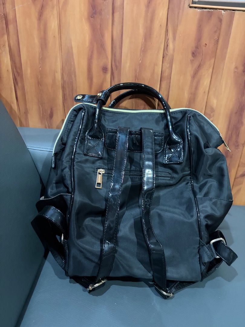 Secosana Backpack (Category: Backpacks) located in Antipolo. Submitted by baneinei (Listing ID 1467115574, Image 3). Description: - Color & Material: Sleek black nylon with glossy patent leather straps and top handles - Compartments: Secure main zipped compartment with light brown lining - Condition: Clean interior and exterior, ready to use, no flaws - Best For: Daily commute, school, or casual everyday use.