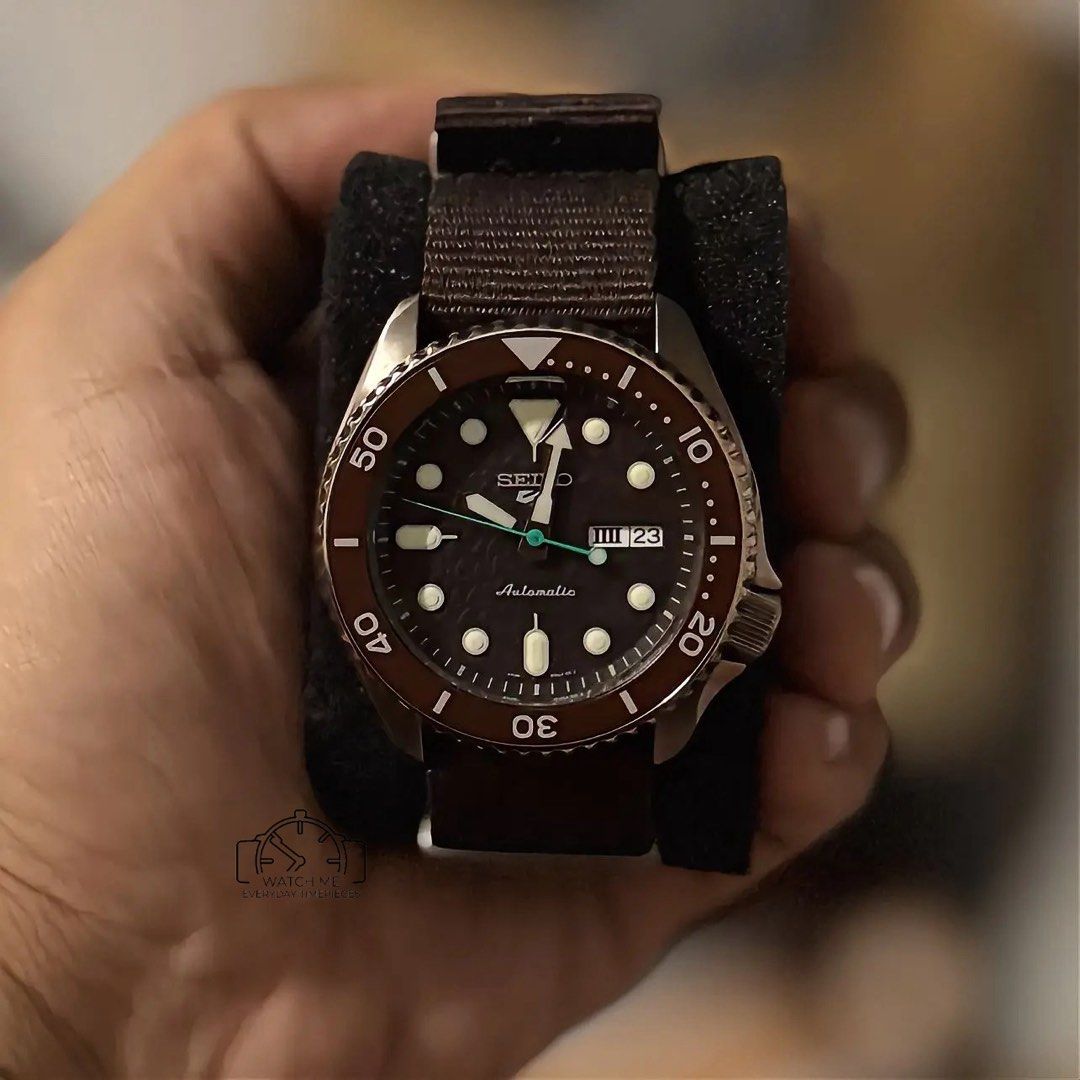 SEIKO SRPD85 - choco dial (Category: Men's Watches) located in Manila. Submitted by watchme_everydaytimepieces (Listing ID 1467117354, Image 2). Description: Seiko 5 Sports (Ref. SRPD85) – Textured Choco Dial 🤎☕ Looking for a versatile daily driver with a unique twist? This piece features a stunning, chocolate-brown textured dial paired with bronze-tone accents and a rugged build. It brings military-inspired utility together with a warm, earthy 