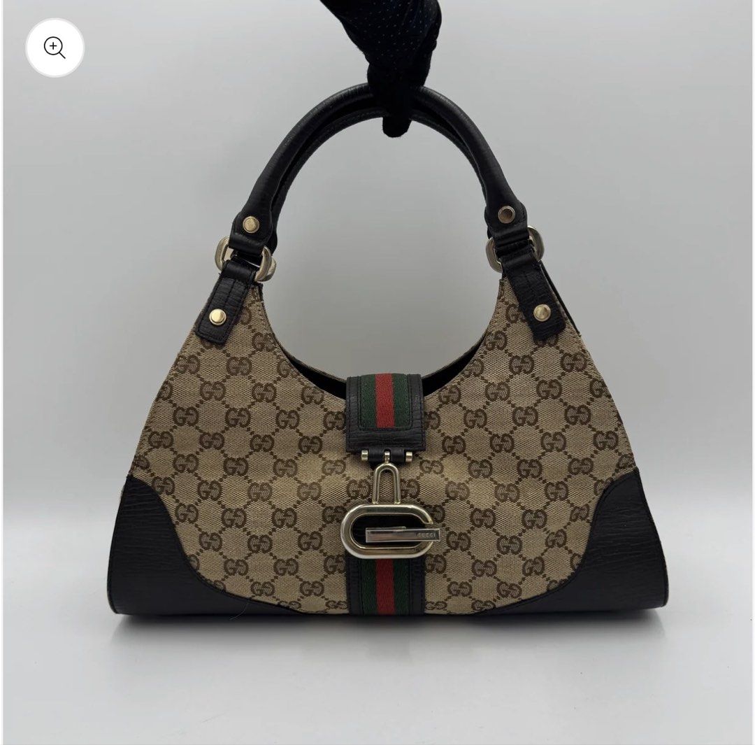 Sherry line junco shoulder bag (Category: Luxury Bags & Wallets) located in Manila. Submitted by angelavict42605 (Listing ID 1467143027, Image 1). Description: - Authentic Gucci hobo bag in beige/ebony GG canvas - Iconic green and red web stripe with black leather trim - Silver-tone hardware and buckle accent - Single leather shoulder strap for easy wear - Clean interior and exterior with serial number tag (130995 467891).