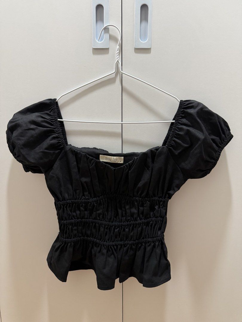 SHU SHI Black Ruffled Top (Category: Blouses) located in Cainta. Submitted by joycexo (Listing ID 1467039113, Image 2). Description: - Brand: SHU SHI - Style: Black Alicia top with square neckline, puff sleeves, and ruched bodice - Hem: Peplum hem at the waist - Size: Small (tag attached) - Condition: Never worn - RFS: Too big for me, this is size small - Bought for 1.1K .